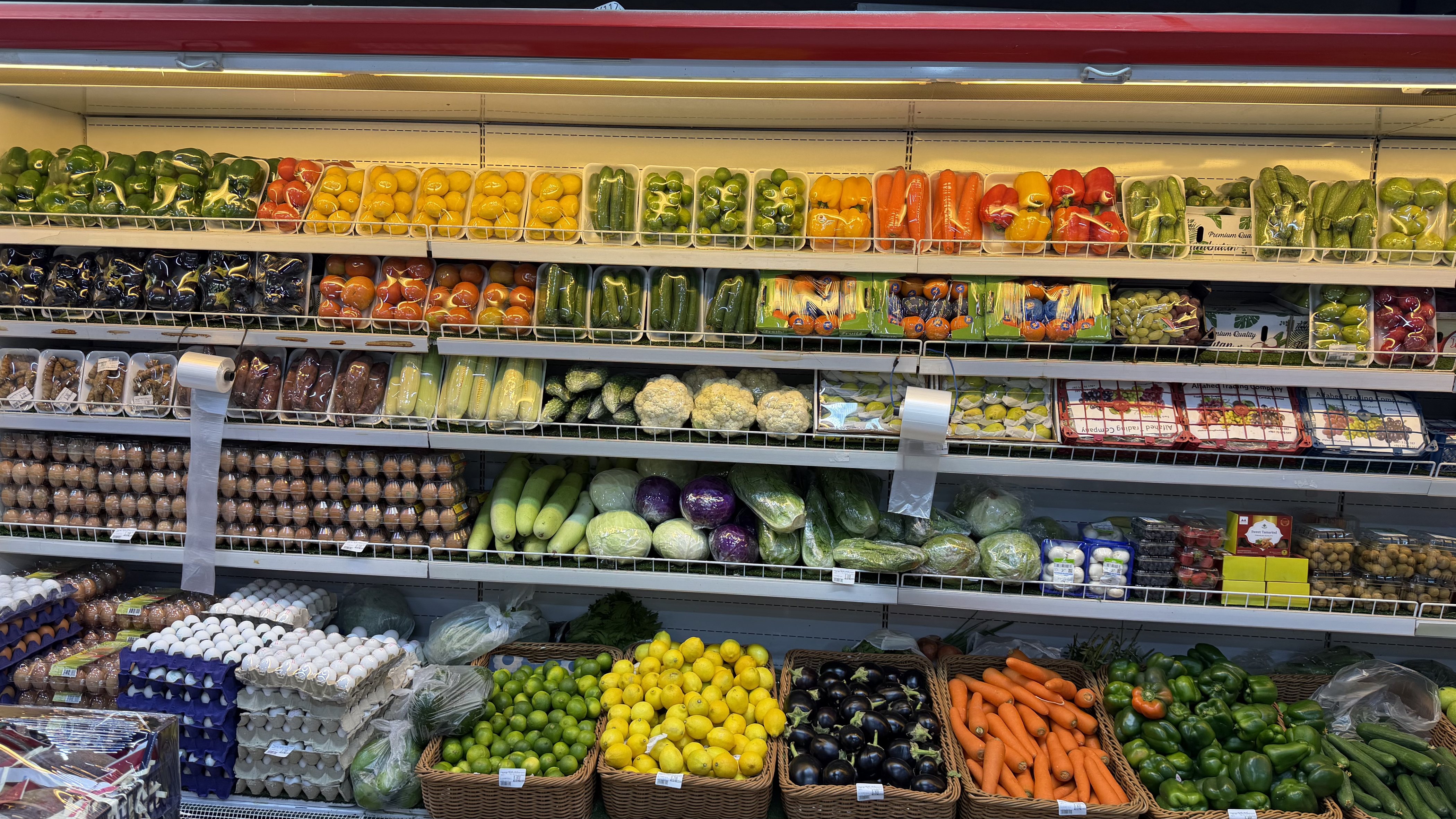 Chilled shelves of vegetables and eggs in an Omani shop